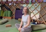Safe and mindful yoga for osteoporosis and recovery - Tessa Spring sitting in a yoga yurt