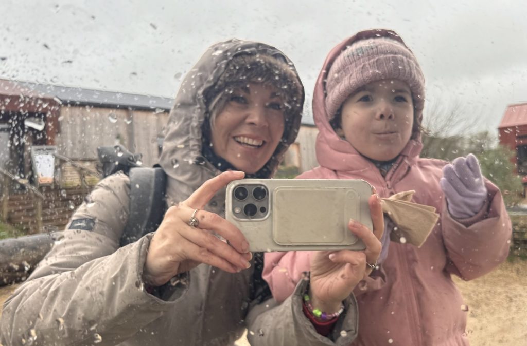 Tessa and her daughter Maeve at the Knepp Estate, smiling in the rain